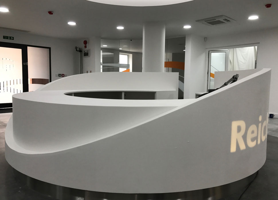 A round white solid surface reception desk